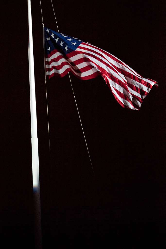 the-american-flag-is-lowered-during-an-evening-parade-036993-1024